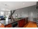 Gourmet kitchen with island featuring granite countertops and stainless steel appliances at 101 Morris St # D, Durham, NC 27701