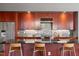 Modern kitchen boasts wood cabinets, dark countertops, stainless steel appliances, and stylish backsplash at 101 Morris St # D, Durham, NC 27701