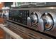 Close-up of stainless steel oven and range with burner controls at 101 Morris St # D, Durham, NC 27701
