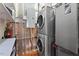 Modern laundry area with stacked washer and dryer, shelving, and visible utility connections at 101 Morris St # D, Durham, NC 27701