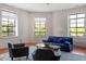 Bright living room featuring hardwood floors, large windows, and stylish furniture at 101 Morris St # D, Durham, NC 27701