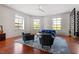 Bright living room featuring hardwood floors, large windows, and stylish furniture at 101 Morris St # D, Durham, NC 27701