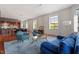 Spacious living area featuring an open layout with sleek hardwood floors and large windows at 101 Morris St # D, Durham, NC 27701