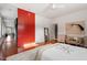 Open primary bedroom space with red accent wall and hardwood floors at 101 Morris St # D, Durham, NC 27701