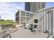 Relaxing rooftop deck featuring stylish outdoor furniture and views of the surrounding city buildings at 101 Morris St # D, Durham, NC 27701