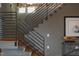 Modern staircase with metal railings and wood steps with brick accent wall and nautical decor at 101 Morris St # D, Durham, NC 27701
