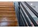 Close up of a staircase with black railings and light hardwood steps and white ceiling at 101 Morris St # D, Durham, NC 27701