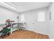 View of basement with storage shelves, wood-look flooring, and white door access at 105 Parkmount Cir, Cary, NC 27519