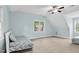Light blue bedroom with a ceiling fan and large windows offering plenty of natural light at 105 Parkmount Cir, Cary, NC 27519
