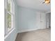 Bedroom featuring neutral carpet, a window, and a closet with sliding doors at 105 Parkmount Cir, Cary, NC 27519