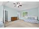 Bright bedroom with neutral carpet, a ceiling fan, and a large window at 105 Parkmount Cir, Cary, NC 27519