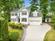 Charming two-story home with a well-manicured lawn, lush landscaping, and a two-car garage at 105 Parkmount Cir, Cary, NC 27519