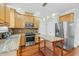 Kitchen featuring stainless steel appliances, granite countertops, wood floors and a center island at 105 Parkmount Cir, Cary, NC 27519