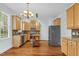 Well-lit kitchen featuring stainless steel appliances, wooden cabinets, mosaic backsplash and wood floors at 105 Parkmount Cir, Cary, NC 27519