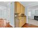 Kitchen area featuring granite countertops, wooden cabinets, mosaic backsplash, and wood floors at 105 Parkmount Cir, Cary, NC 27519