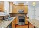 Kitchen with stainless steel appliances, granite countertops, wooden cabinets and a double sink at 105 Parkmount Cir, Cary, NC 27519