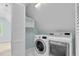 Bright laundry room featuring a modern washer and dryer, and functional shelving at 105 Parkmount Cir, Cary, NC 27519
