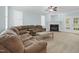 Spacious living room with a cozy fireplace, large windows, and comfortable seating at 105 Parkmount Cir, Cary, NC 27519