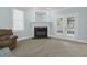 Bright living room with a fireplace, neutral carpet, and access to an outdoor space at 105 Parkmount Cir, Cary, NC 27519