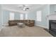 Comfortable living room with a large sectional sofa, ceiling fan, fireplace and multiple windows at 105 Parkmount Cir, Cary, NC 27519