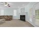 Living room featuring a fireplace, ceiling fan and french doors to the exterior at 105 Parkmount Cir, Cary, NC 27519