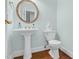 Traditional powder room features pedestal sink, gold finishes, and hardwood floors at 105 Parkmount Cir, Cary, NC 27519