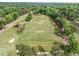 Bird's eye view of the golf course practice range, and surrounding green areas at 106 Birkhaven Dr, Cary, NC 27518