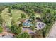 Aerial view showcasing the golf club amenities, including the driving range, putting green, and clubhouse at 106 Birkhaven Dr, Cary, NC 27518