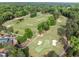 Panoramic view of the golf course with manicured greens, sand bunkers, and mature trees at 106 Birkhaven Dr, Cary, NC 27518