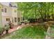 Expansive backyard with a patio featuring a fountain, outdoor seating, a swing, and lush greenery at 106 Birkhaven Dr, Cary, NC 27518