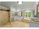 Luxurious bathroom boasts a soaking tub, walk-in shower, double vanity sinks, and stone countertops at 106 Birkhaven Dr, Cary, NC 27518