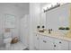 Bright bathroom featuring white cabinets, a large mirror, and a separate shower at 106 Birkhaven Dr, Cary, NC 27518