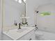 Bright bathroom with white fixtures, a vanity, a tub/shower combo, and a large mirror at 106 Birkhaven Dr, Cary, NC 27518