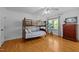 Bright bedroom with a bunk bed, hardwood floors, a ceiling fan, and a window providing natural light at 106 Birkhaven Dr, Cary, NC 27518