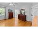 Bedroom with hardwood floors, two dressers, and an adjoining bathroom entrance providing functionality at 106 Birkhaven Dr, Cary, NC 27518