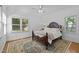 Cozy bedroom features a decorative bed frame, a patterned rug, and plenty of natural light at 106 Birkhaven Dr, Cary, NC 27518