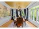 Elegant dining room featuring hardwood floors, a large window, and an ornate chandelier at 106 Birkhaven Dr, Cary, NC 27518