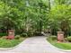 Circular driveway with brick pillars and landscaped beds adds to the curb appeal at 106 Birkhaven Dr, Cary, NC 27518