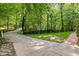 Long driveway surrounded by lush greenery leads up to this stunning home at 106 Birkhaven Dr, Cary, NC 27518