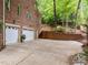 Long driveway leading to garages with well-kept landscaping and mature trees at 106 Birkhaven Dr, Cary, NC 27518