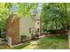 A view of the home's exterior showcasing brick and siding, windows, and a well-manicured lawn and garden at 106 Birkhaven Dr, Cary, NC 27518