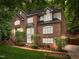 Stately two-story brick home featuring a landscaped front yard and a black shingle roof at 106 Birkhaven Dr, Cary, NC 27518
