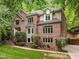 Charming two-story brick home with well-maintained lawn and surrounding trees at 106 Birkhaven Dr, Cary, NC 27518