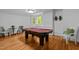 Game room featuring pool table with red felt, hardwood floors, and comfortable seating at 106 Birkhaven Dr, Cary, NC 27518