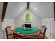 Attic game room showcases a poker table with green felt, hardwood floors, and natural light from a window at 106 Birkhaven Dr, Cary, NC 27518