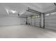 Spacious and clean three car garage with white painted floor, walls and ceilings at 106 Birkhaven Dr, Cary, NC 27518