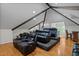 Spacious home theater in attic features tiered seating, hardwood floors and recessed lighting at 106 Birkhaven Dr, Cary, NC 27518