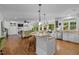 Open-concept kitchen featuring a center island with granite countertops and stainless steel appliances at 106 Birkhaven Dr, Cary, NC 27518
