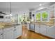Bright kitchen with white cabinets, stainless steel appliances, and hardwood floors at 106 Birkhaven Dr, Cary, NC 27518