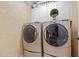Modern laundry room with front-load washer and dryer and ample storage space above at 106 Birkhaven Dr, Cary, NC 27518